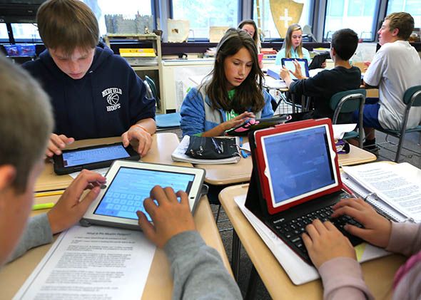 Students in teacher Cynthia McClellan's eighth grade social science and history class at the Blake Middle School use their iPads during class.