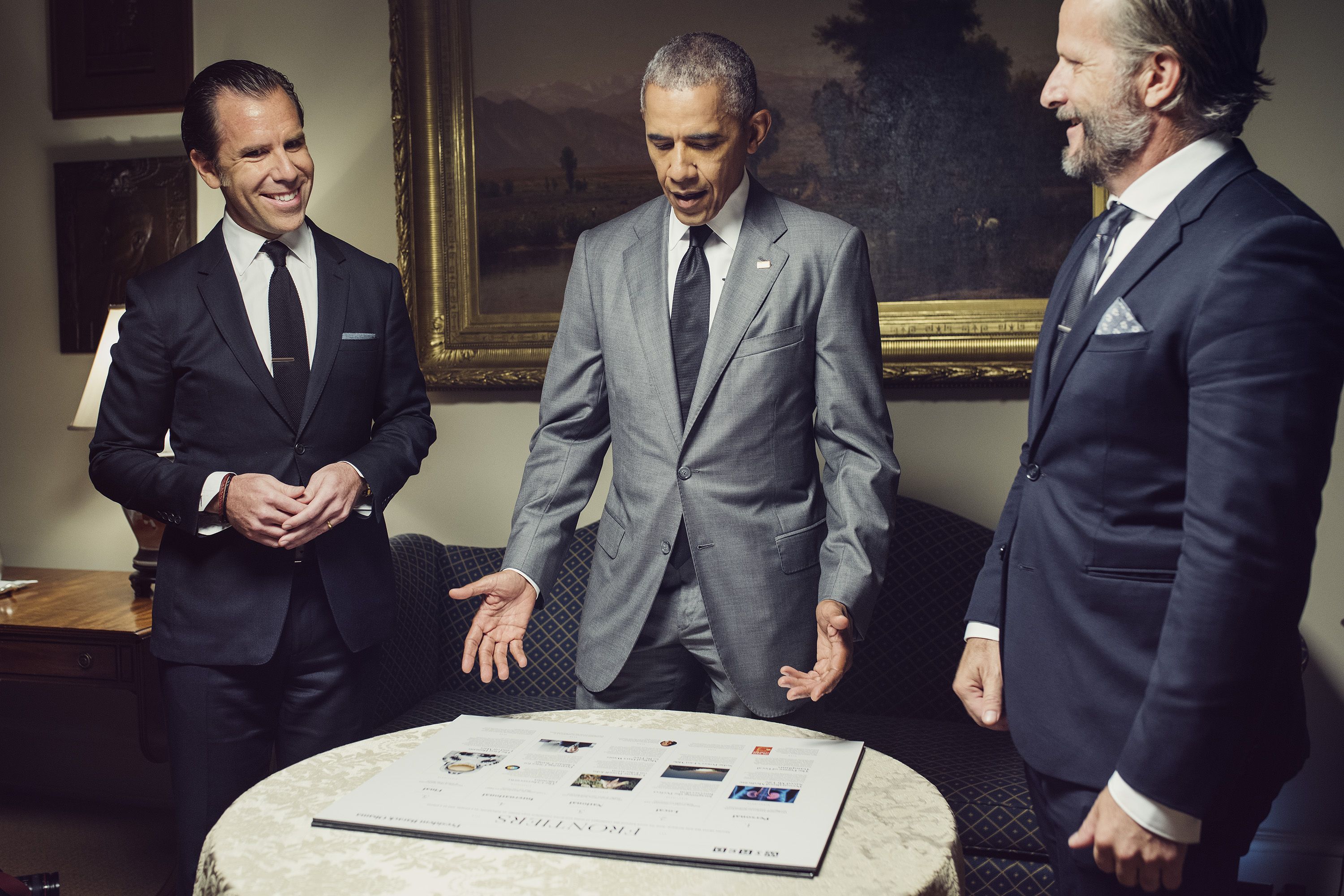 President Barack Obama reviews layout boards in the Roosevelt Room with Wired Magazine Editor in Chief Scott Dadich and Editorial Director Rob Capps for the issue he his guest editing.